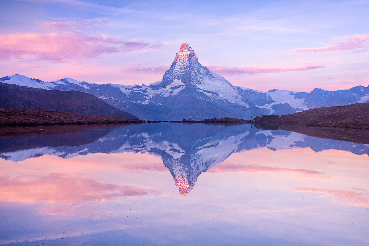 Perfect reflection of mount Matterhon (Mont Cervin) on Stellisee. Early morning shot.